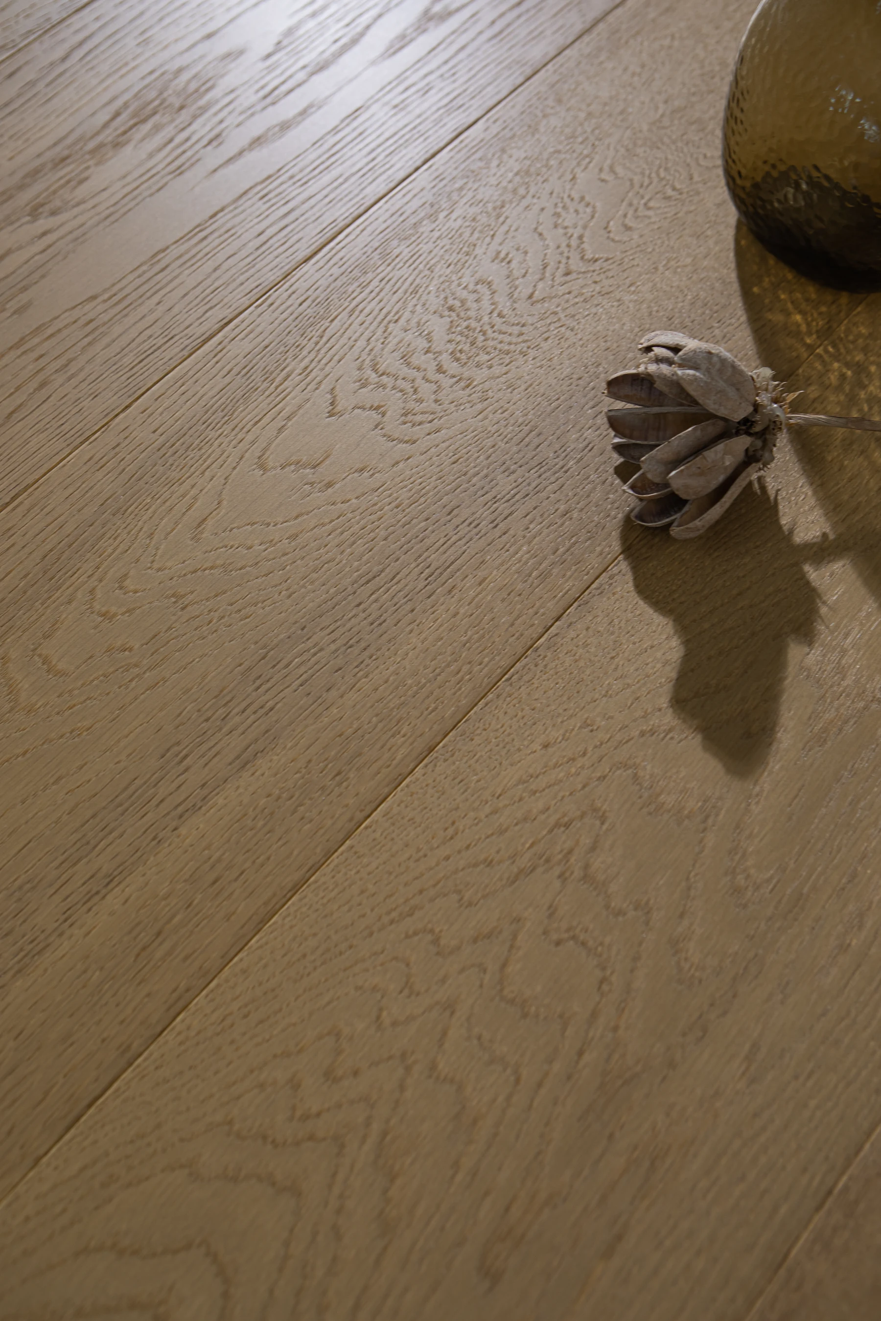 Oak flooring with a glass vase and soft directional shadows